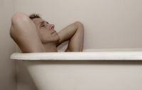 Man soaking in hot bath